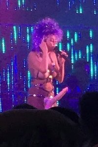 Miley Cyrus performs topless while wearing a strap-on eggplant