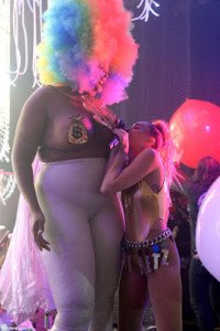 Miley Cyrus performs topless while wearing a strap-on eggplant